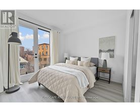 A bedroom with a large bed and a view of the city.