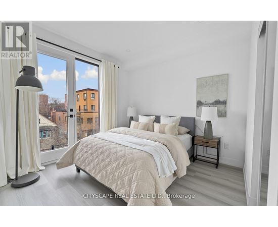 A bedroom with a large bed and a view of the city.