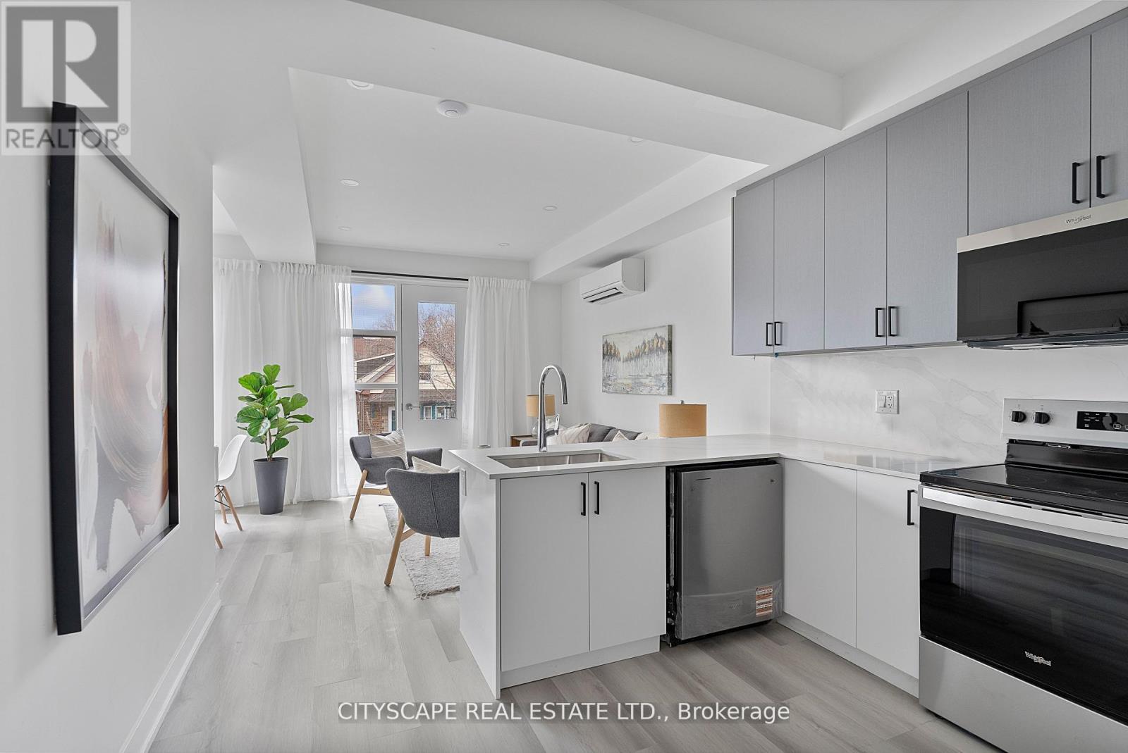 A modern kitchen with white cabinets and a large island.