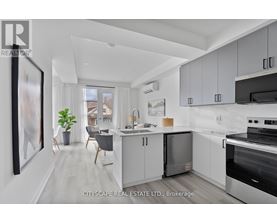 A modern kitchen with white cabinets and a large island.