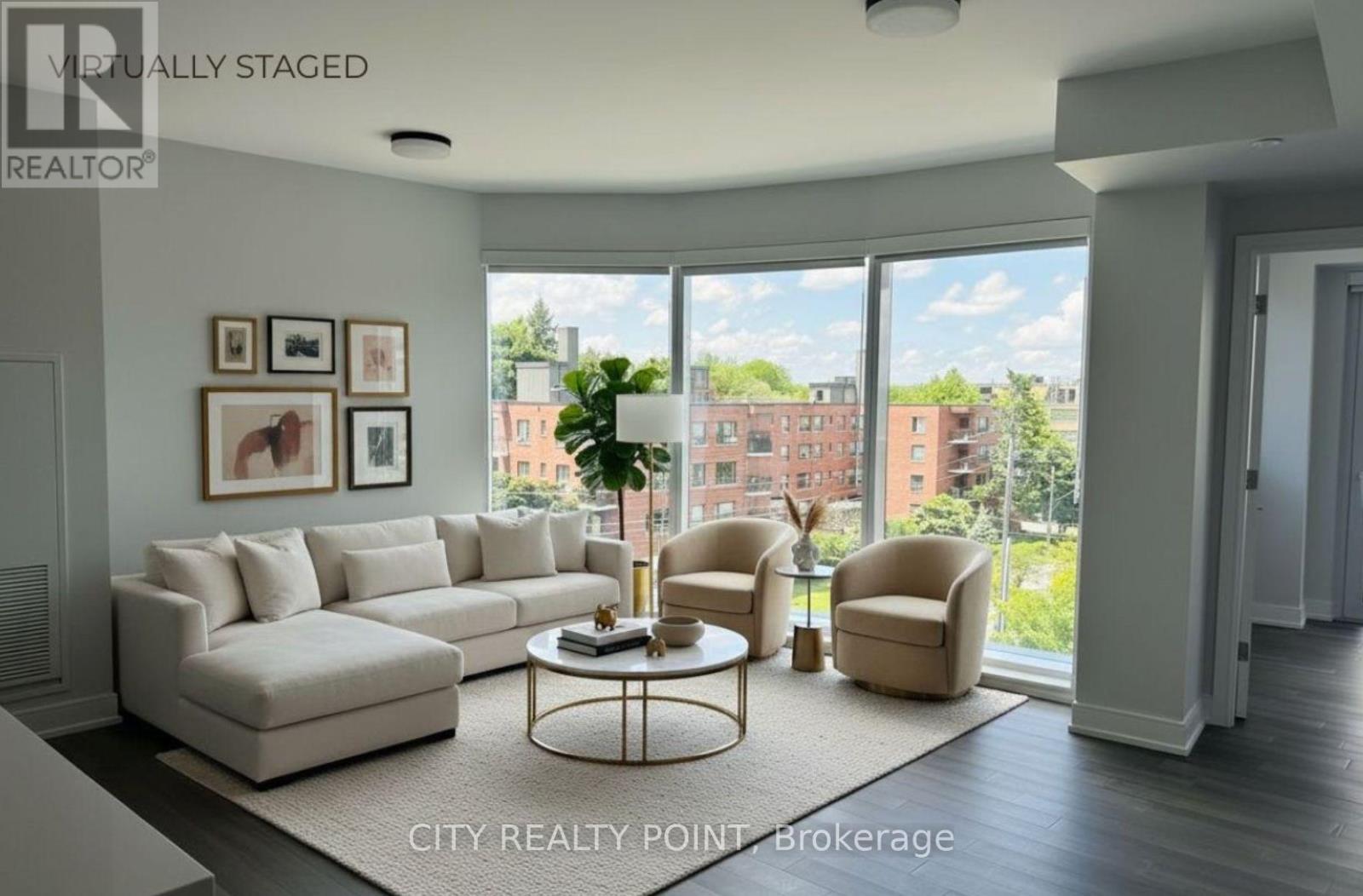 A living room with a large window overlooking a cityscape.