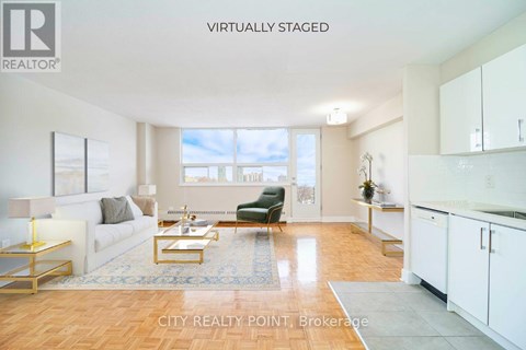 A virtual staged living room with a couch, coffee table, and kitchen area.