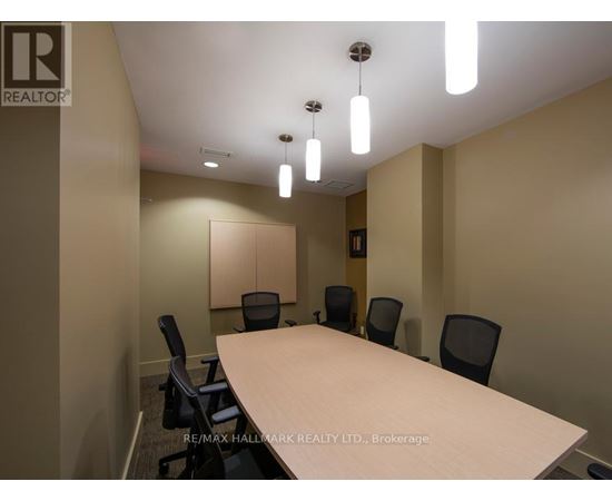 A conference room with a long table and chairs.