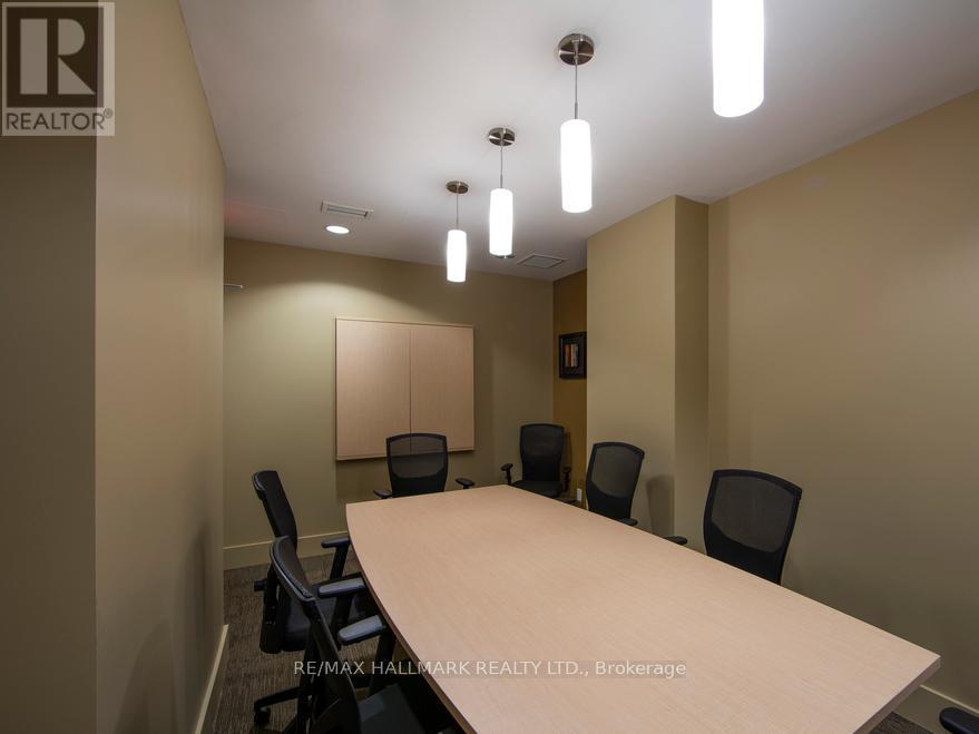 A conference room with a long table and chairs.