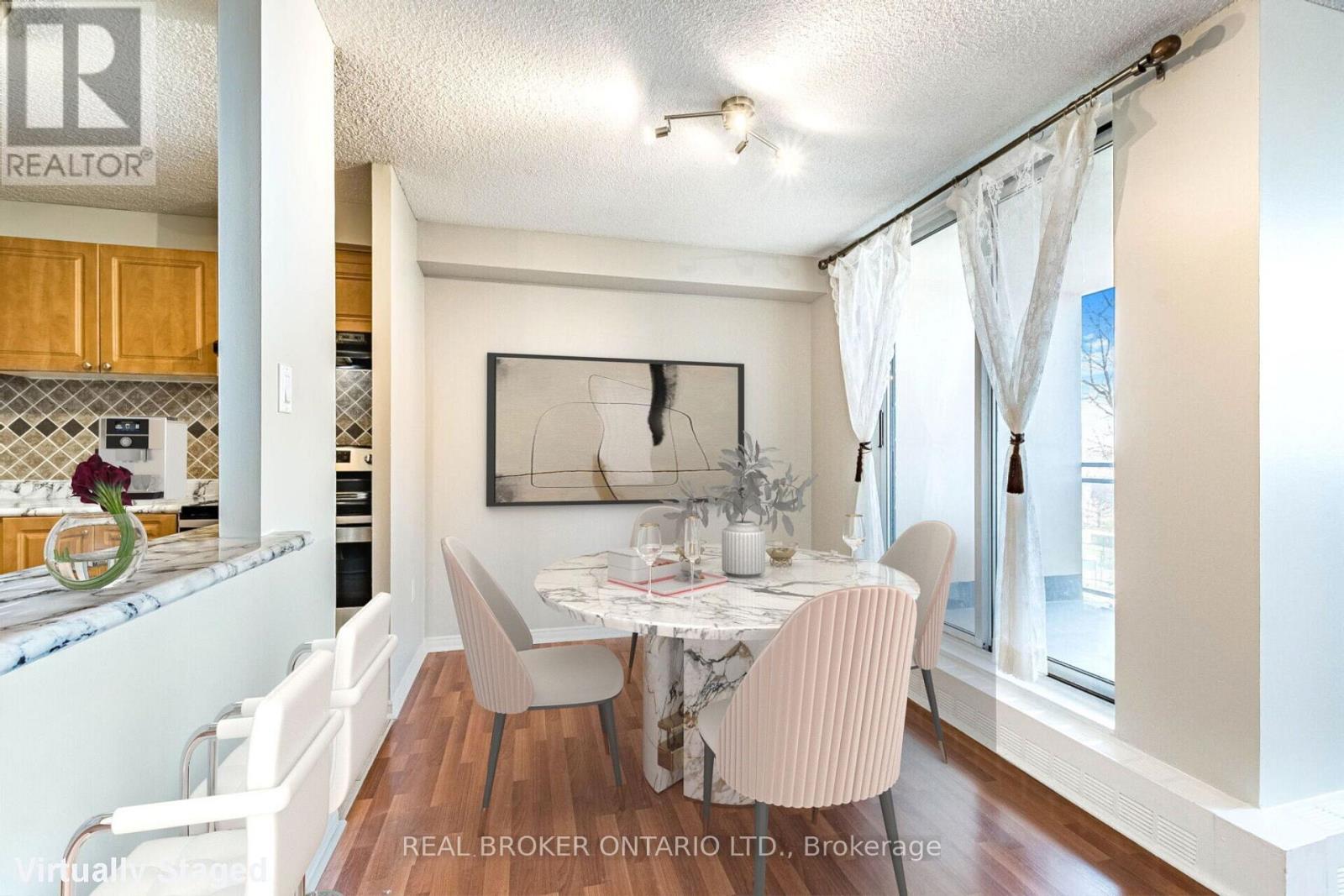 A dining room with a table set for two and a painting on the wall.