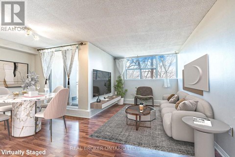 A living room with a white couch and a coffee table.