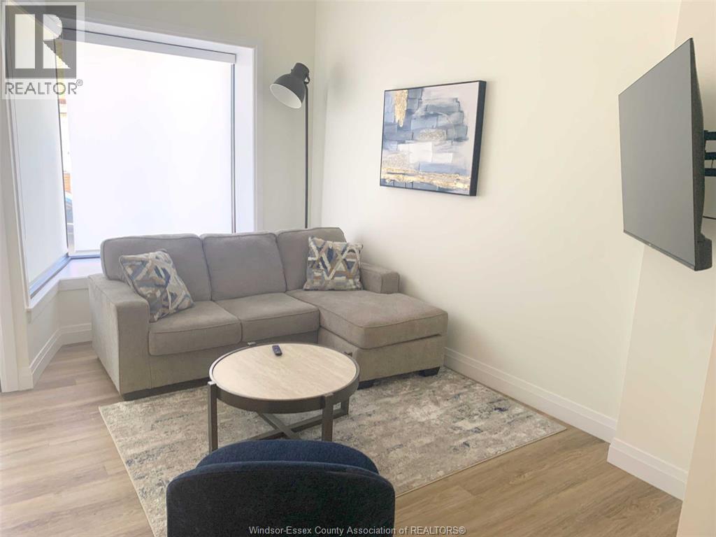 A living room with a grey couch and a small table.
