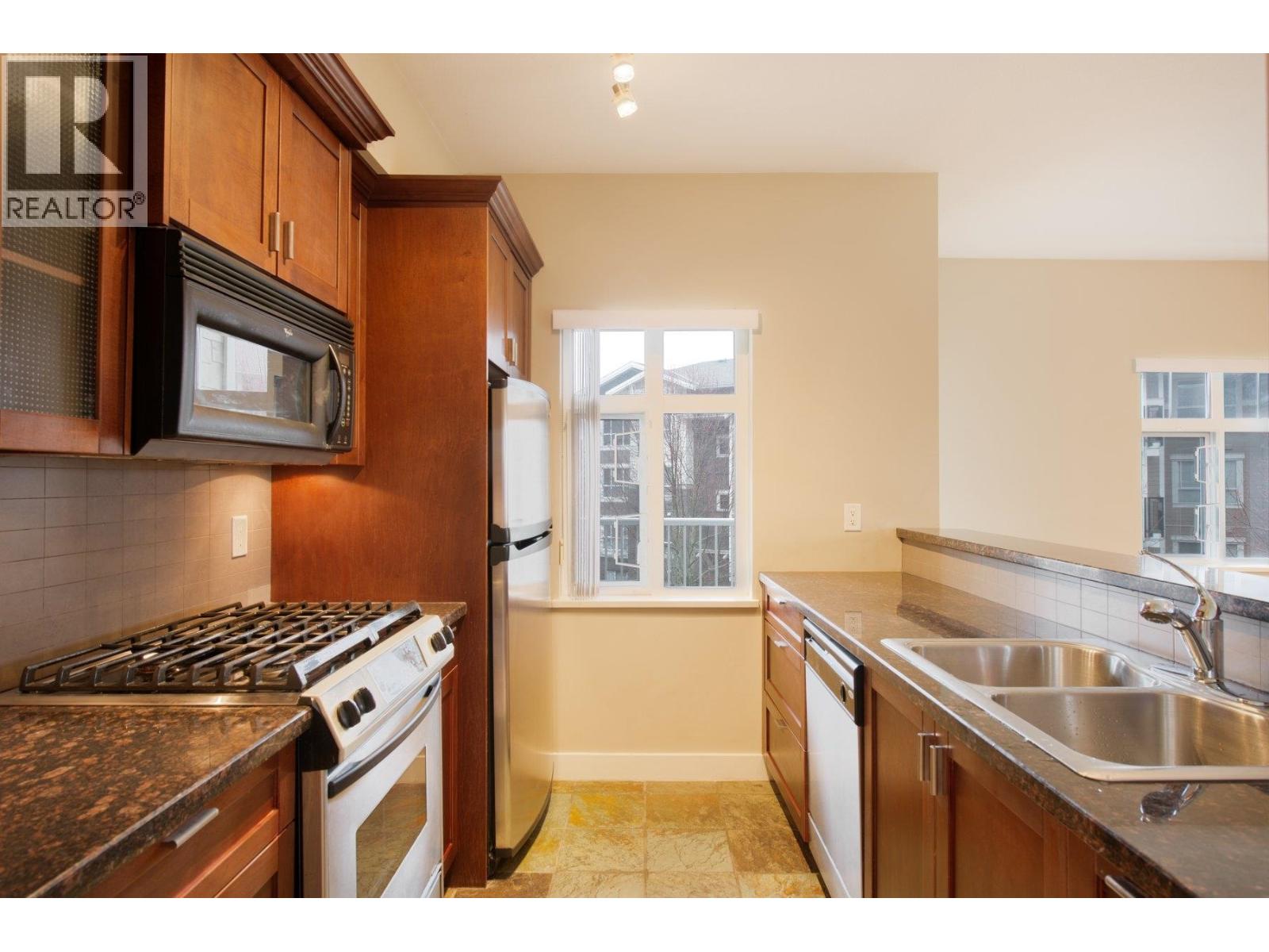 A kitchen with a stove top oven and a microwave.