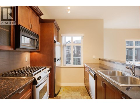 A kitchen with a stove top oven and a microwave.
