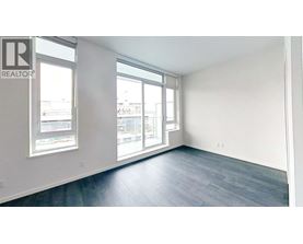 A realtor's office with a large window and a wooden floor.