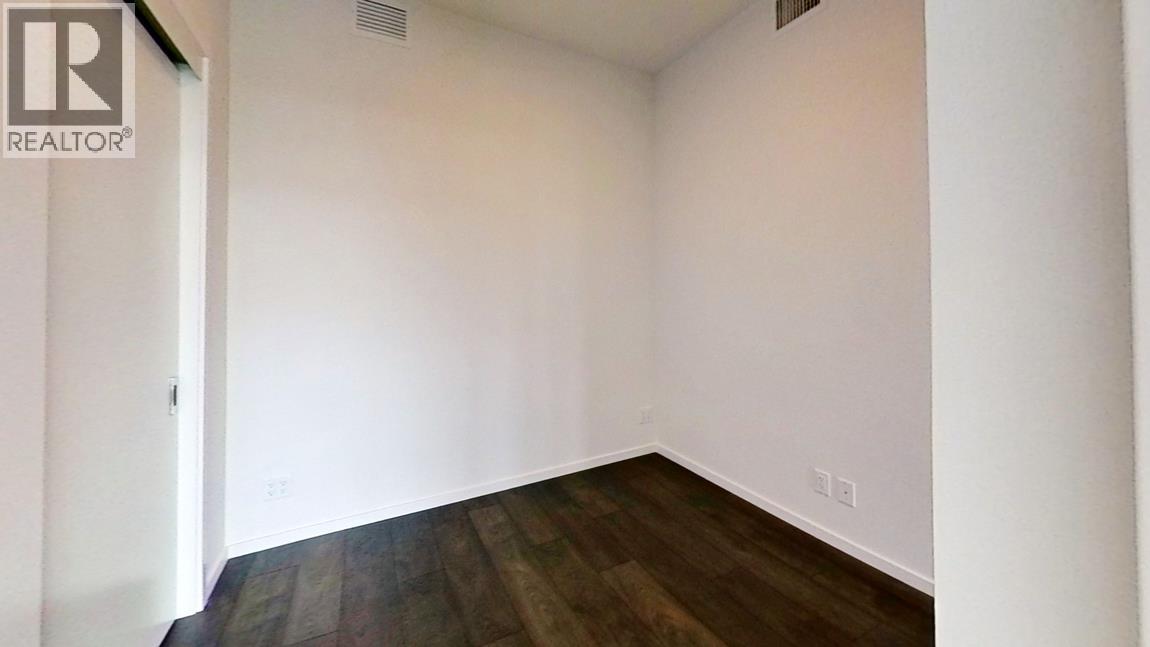 A room with a wooden floor and white walls.