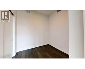 A room with a wooden floor and white walls.