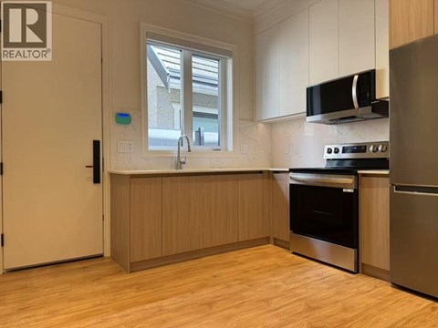 A kitchen with wooden cabinets and stainless steel appliances.