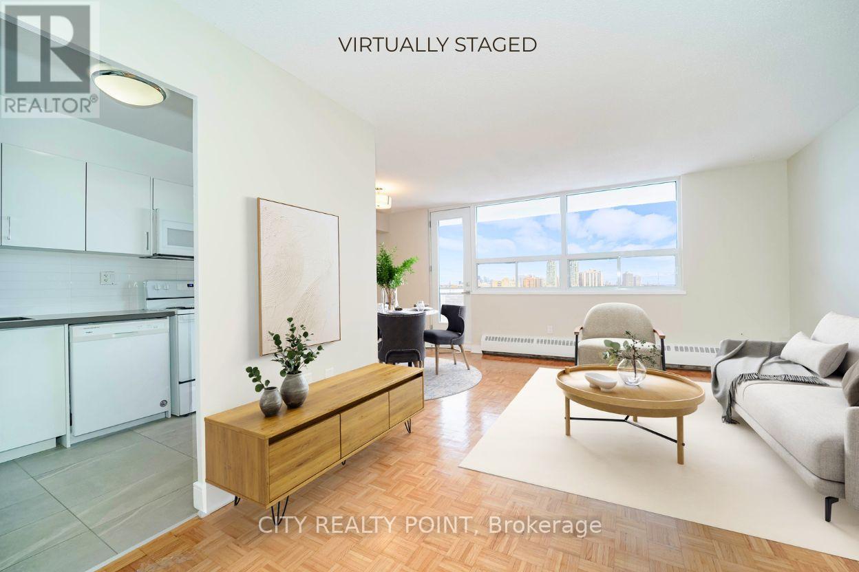 A modern living room with a kitchen area in the background.