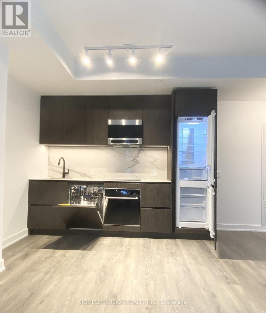 A modern kitchen with dark brown cabinets and stainless steel appliances.