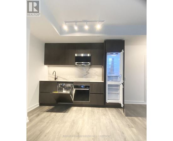 A modern kitchen with dark brown cabinets and stainless steel appliances.
