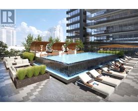 A pool area with lounge chairs and a waterfall.
