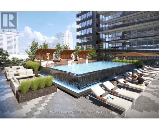 A pool area with lounge chairs and a waterfall.
