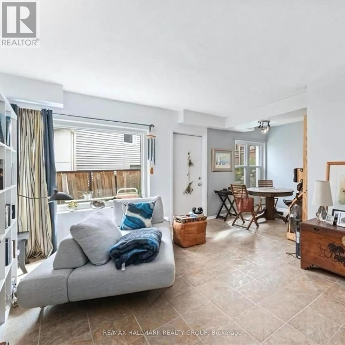 A living room with a grey couch and a wooden side table.