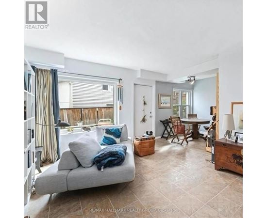 A living room with a grey couch and a wooden side table.