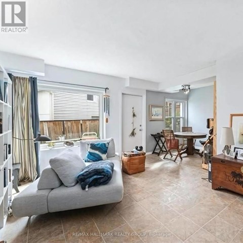 A living room with a grey couch and a wooden side table.