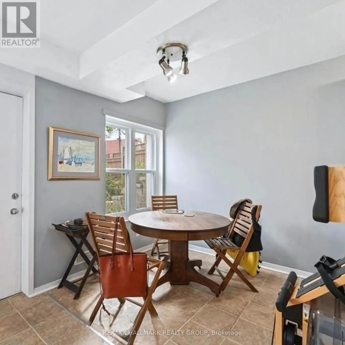 A dining room with a table and chairs.