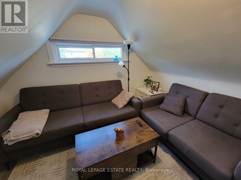 A living room with a brown couch and a wooden coffee table.