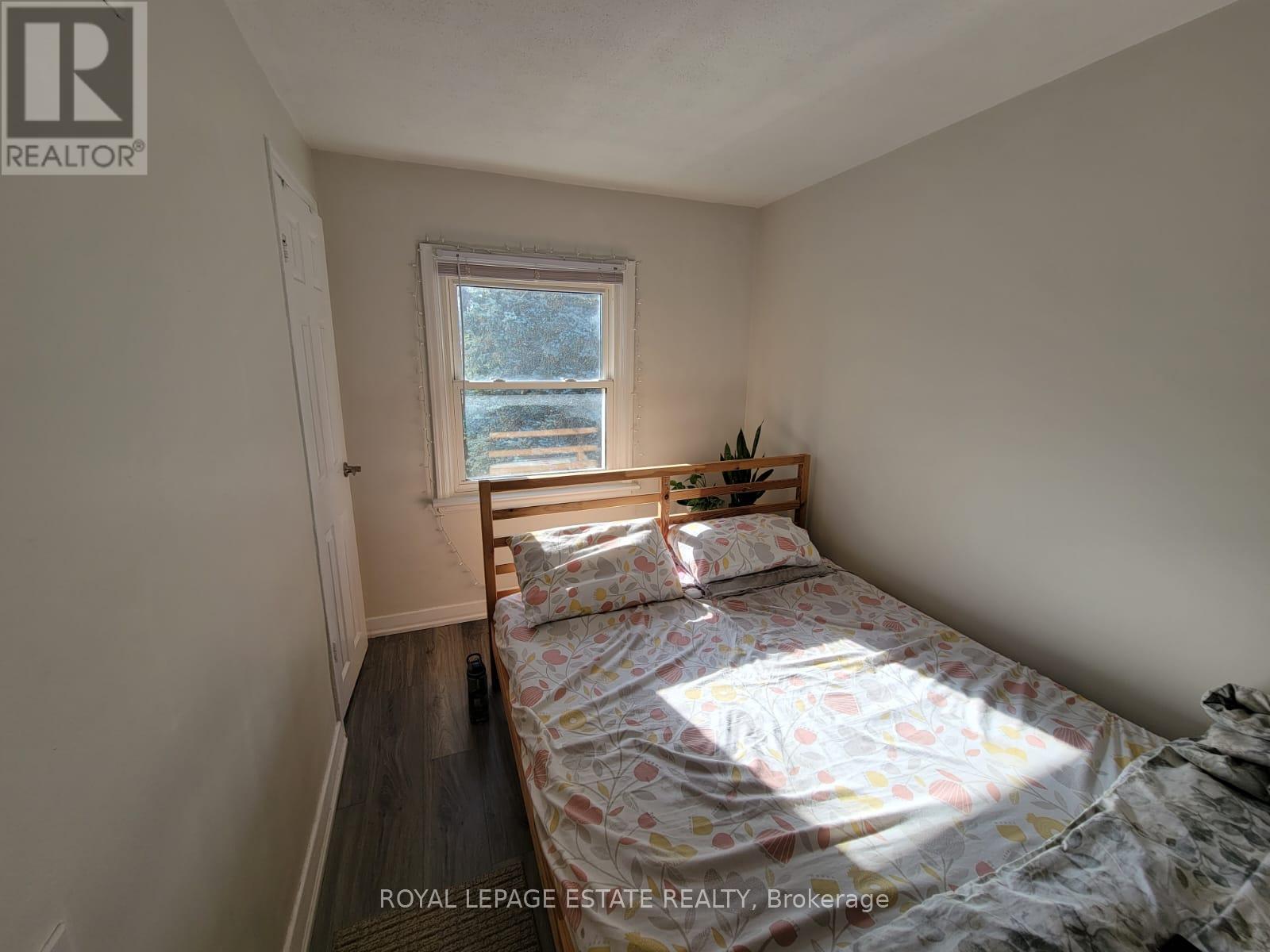 A bedroom with a bed and a window.