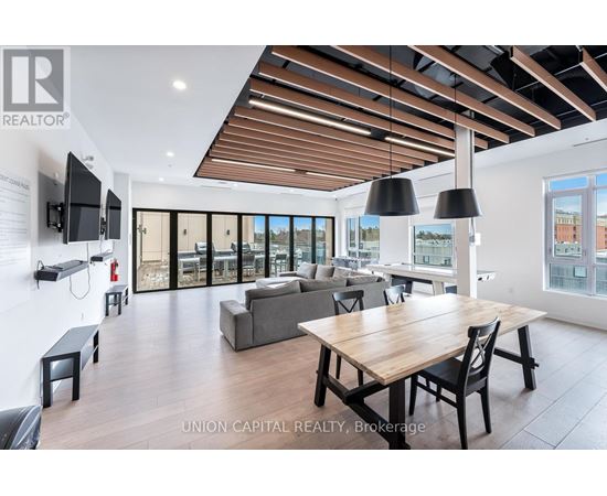 A modern living room with a wooden table and chairs.
