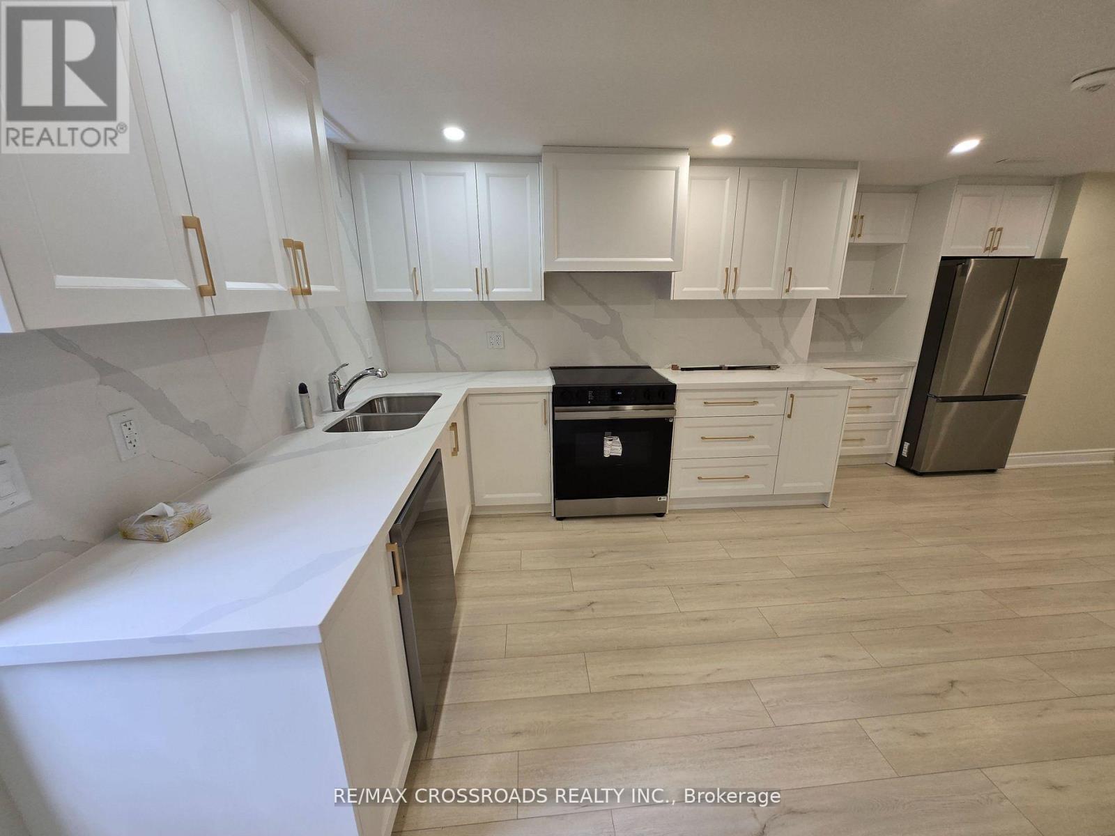 A kitchen with white cabinets and a black stove top oven.