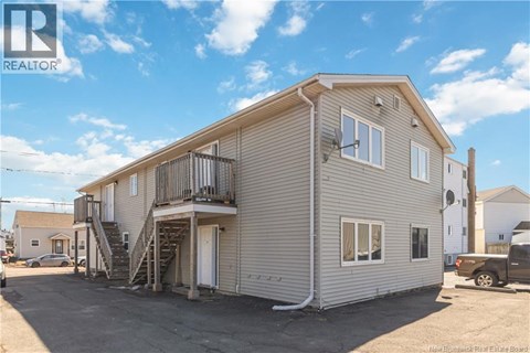 A two-story house with a balcony on the upper floor.