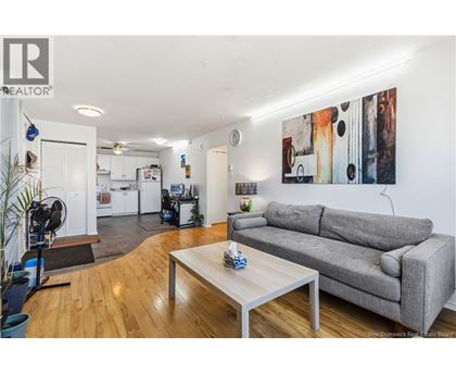 A living room with a grey couch and a coffee table.