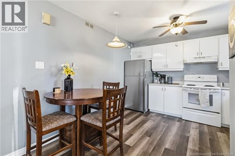 A kitchen with a table and chairs.