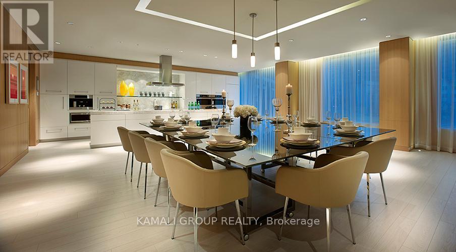 A modern dining room with a glass table and chairs.