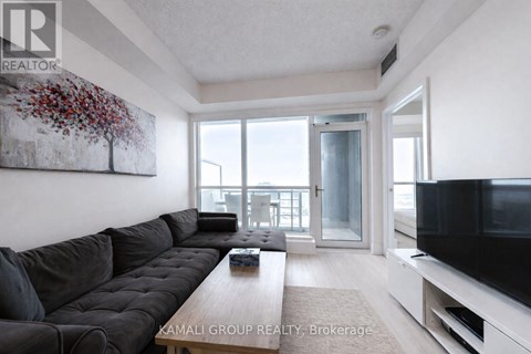 A living room with a grey sofa and a television.