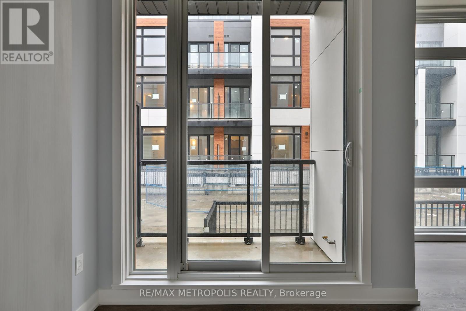 A view of a balcony from a window in a building.