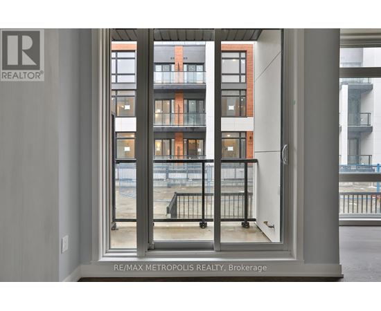 A view of a balcony from a window in a building.
