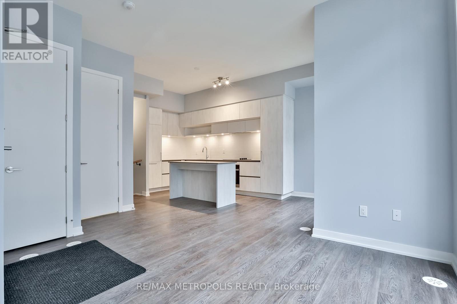 A spacious room with a white table and chairs in the middle.