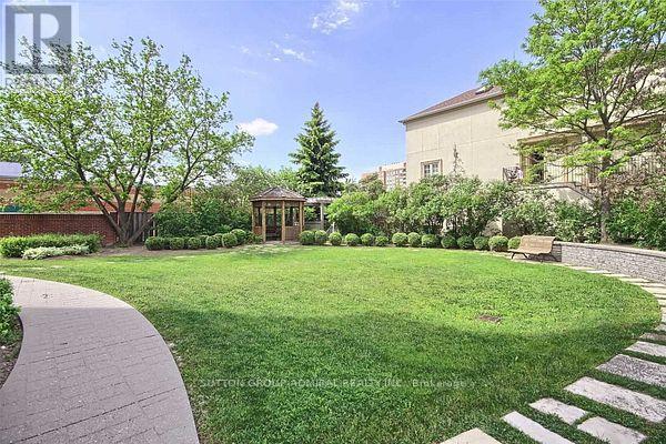 A well-maintained garden with a gazebo and a stone pathway.