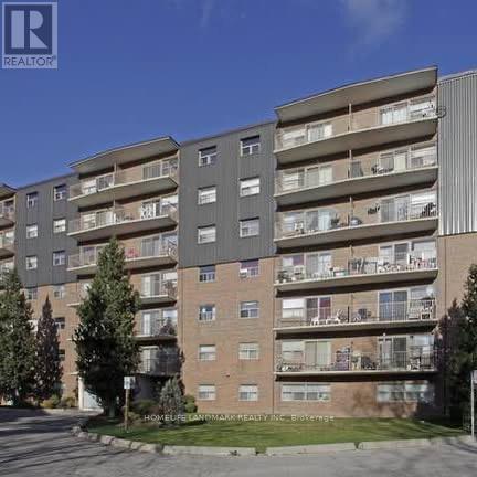 A large apartment building with balconies and multiple stories.