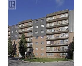 A large apartment building with balconies and multiple stories.