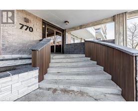A stone staircase leads to a doorway in a modern home.