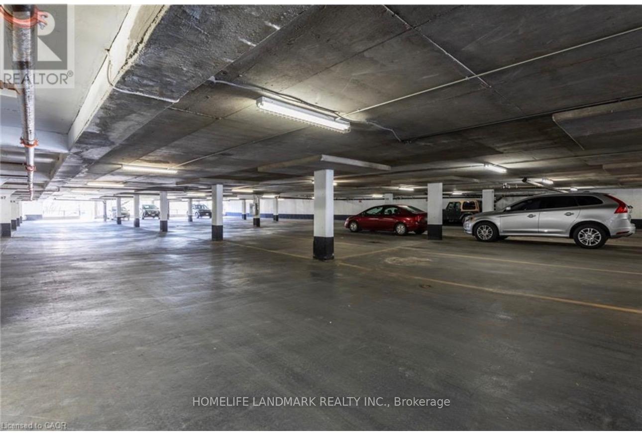 A parking garage with a few cars parked in it.