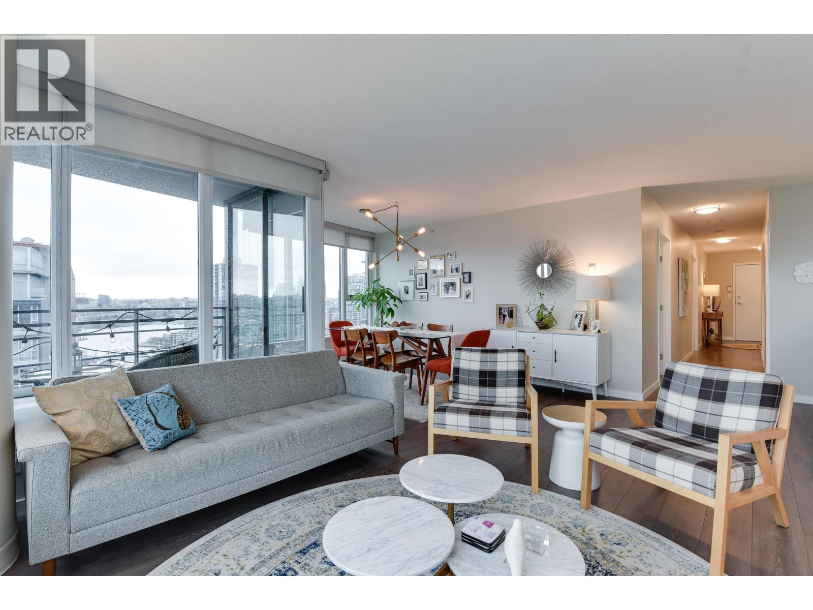 A living room with a grey couch and a white coffee table.