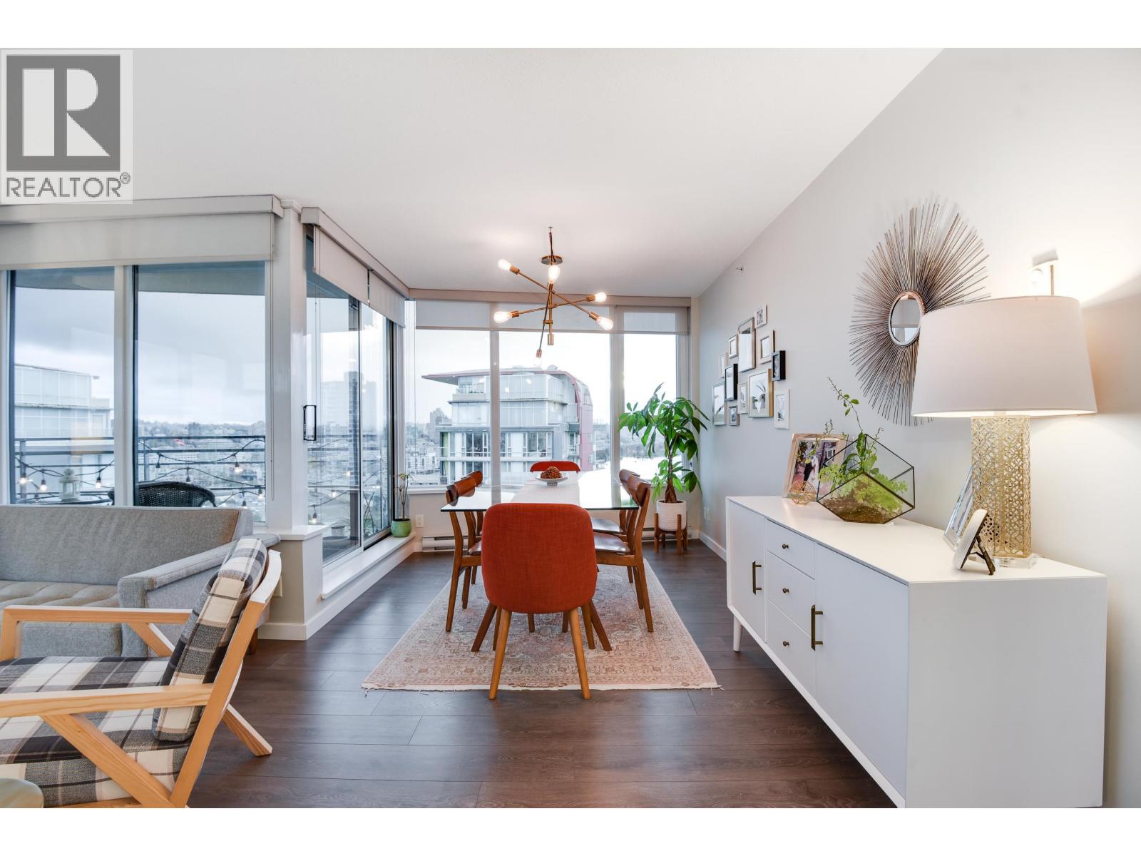 A dining room with a table set for four and a view of the city.