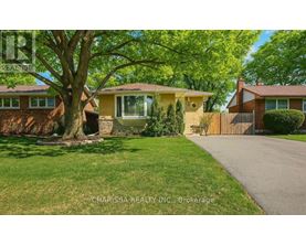 A house with a tree in front of it.