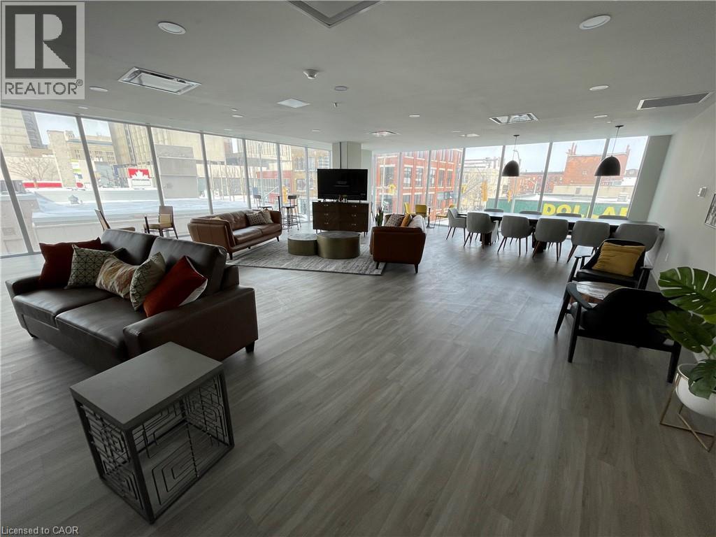 A large, modern living room with a variety of seating options and a flat-screen TV.