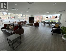 A large, modern living room with a variety of seating options and a flat-screen TV.