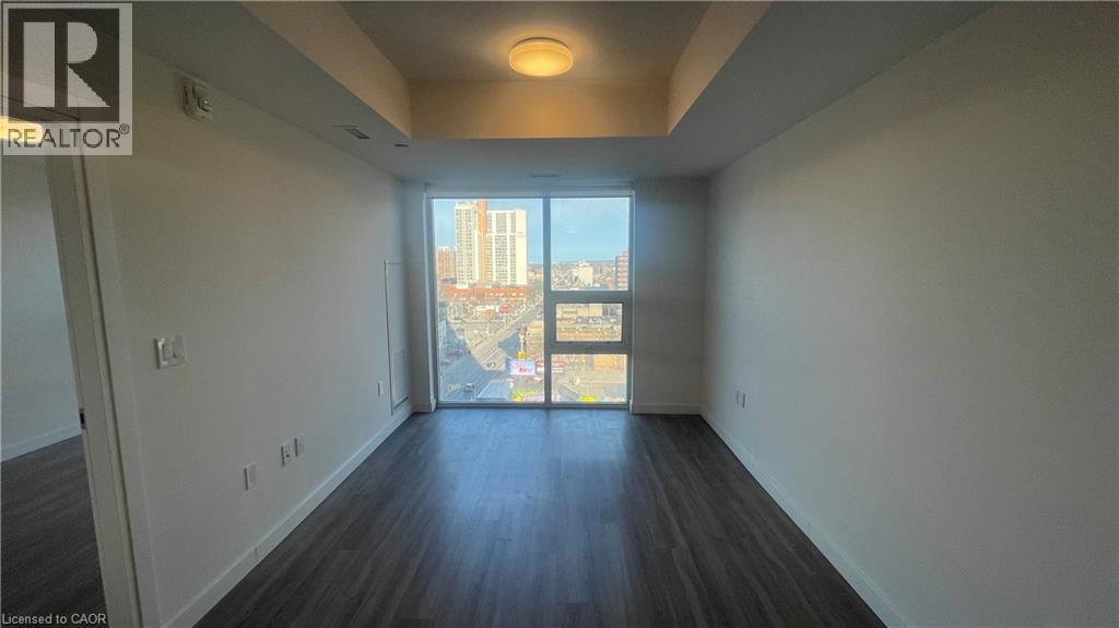 A spacious room with a view of the city through a large window.