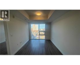 A spacious room with a view of the city through a large window.